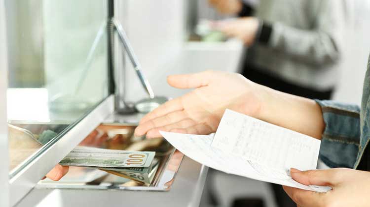 bank cleaning services - teller handing money